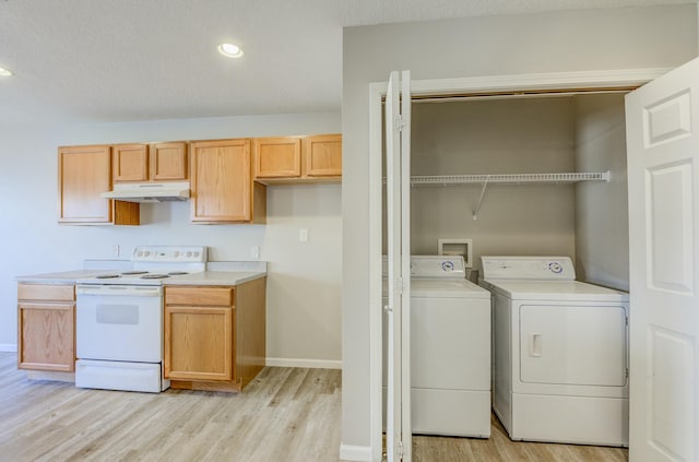 washroom featuring light wood finished floors, recessed lighting, washing machine and dryer, laundry area, and baseboards