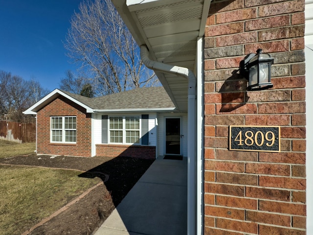 exterior details with brick siding and fence