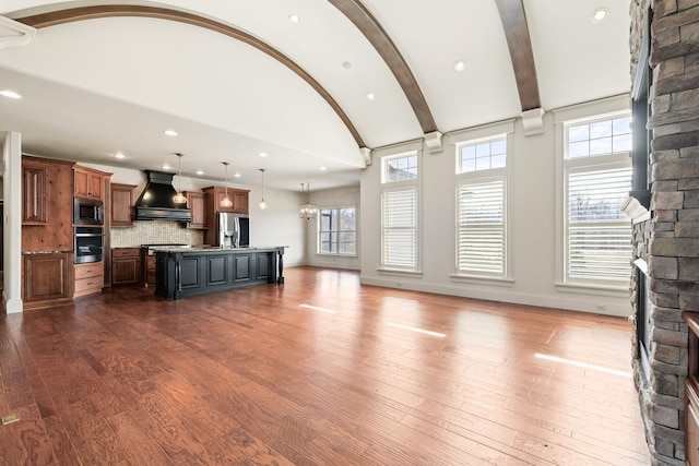 unfurnished living room featuring vaulted ceiling with beams, dark wood-style floors, baseboards, and recessed lighting