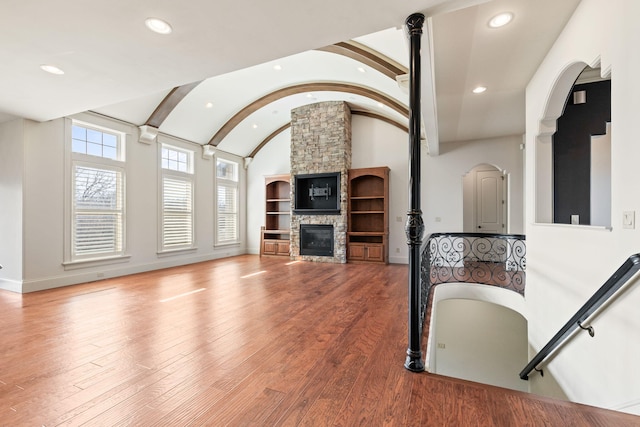 living area with recessed lighting, hardwood / wood-style flooring, and baseboards