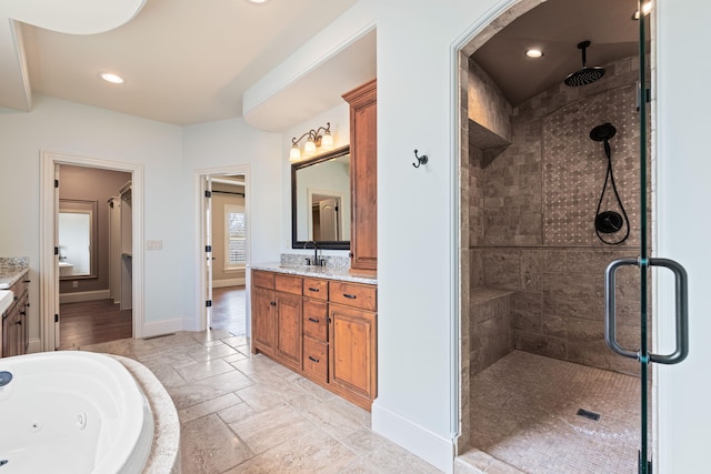 full bath with a stall shower, baseboards, a jetted tub, vanity, and recessed lighting