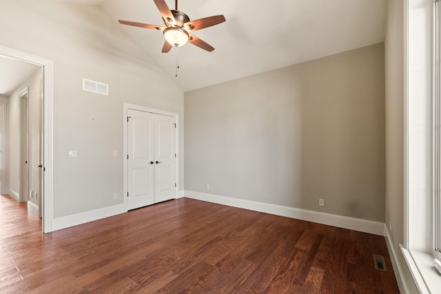 unfurnished room featuring wood finished floors, visible vents, and baseboards