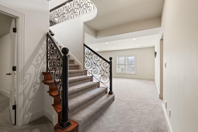 stairs featuring baseboards, carpet flooring, and recessed lighting