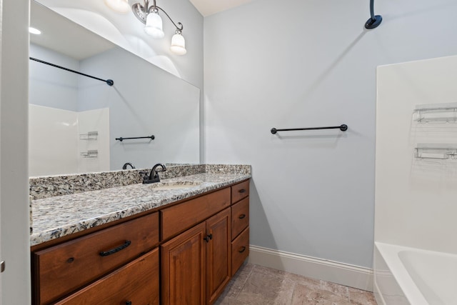 full bath featuring baseboards and vanity