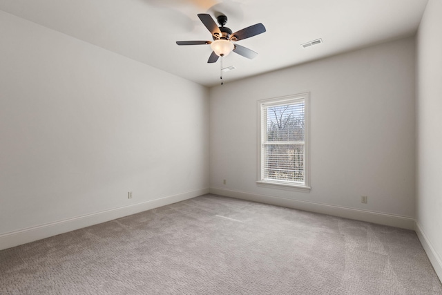 empty room featuring baseboards, visible vents, a ceiling fan, and light colored carpet