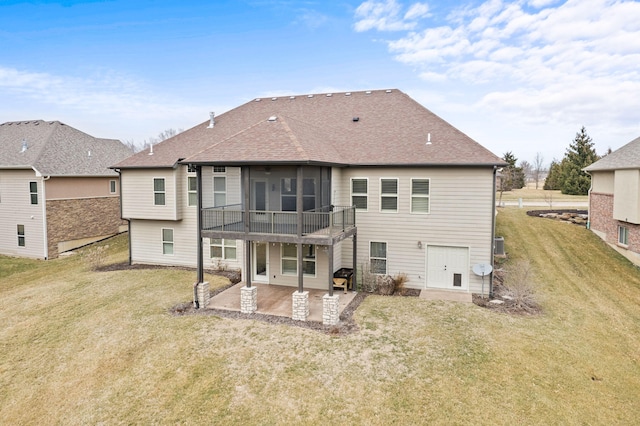 rear view of property with a yard, a sunroom, roof with shingles, and a patio