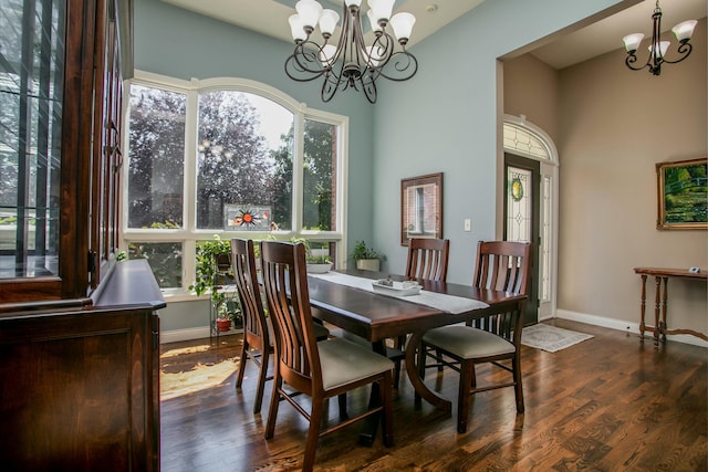 dining space with a chandelier, baseboards, and wood finished floors