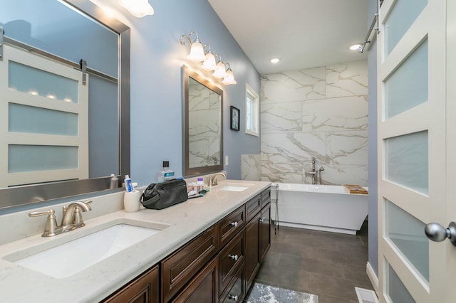 bathroom with a freestanding tub, visible vents, a sink, and double vanity