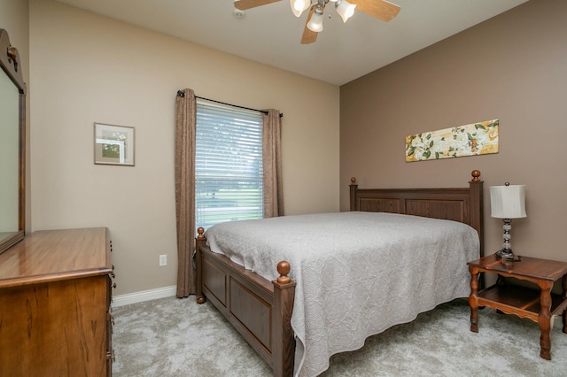 bedroom with ceiling fan, baseboards, and light colored carpet