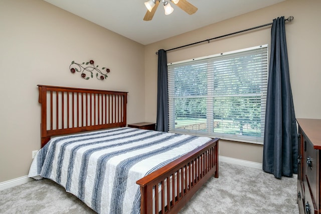 bedroom with carpet, a ceiling fan, and baseboards