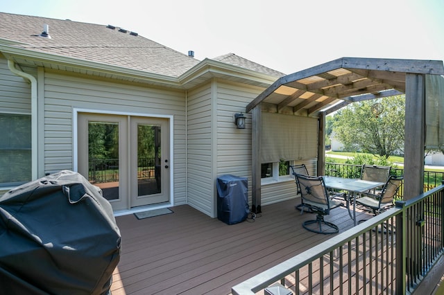 wooden terrace with outdoor dining space, grilling area, and a pergola