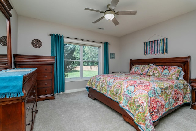 bedroom with a ceiling fan, baseboards, visible vents, and carpet flooring