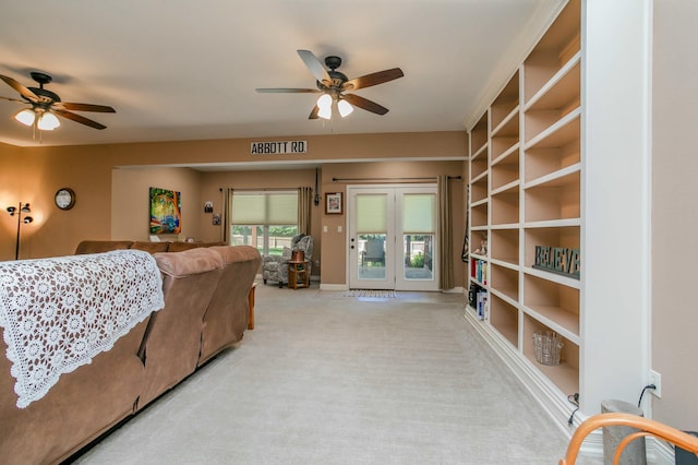 living room with light carpet and a ceiling fan