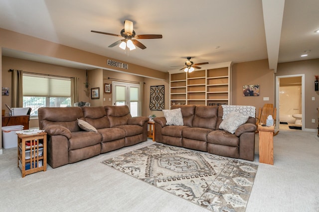 living room featuring a ceiling fan, carpet, and visible vents