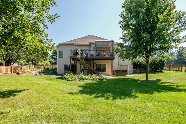 back of house featuring a hot tub, a wooden deck, a fenced backyard, stairway, and a yard