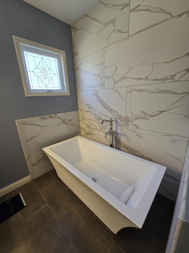 full bathroom with a freestanding tub, visible vents, and tile walls