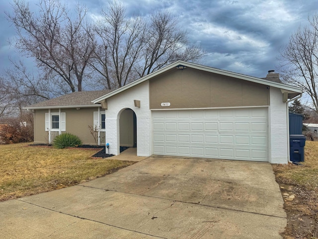 ranch-style house featuring a garage, driveway, roof with shingles, a chimney, and a front yard