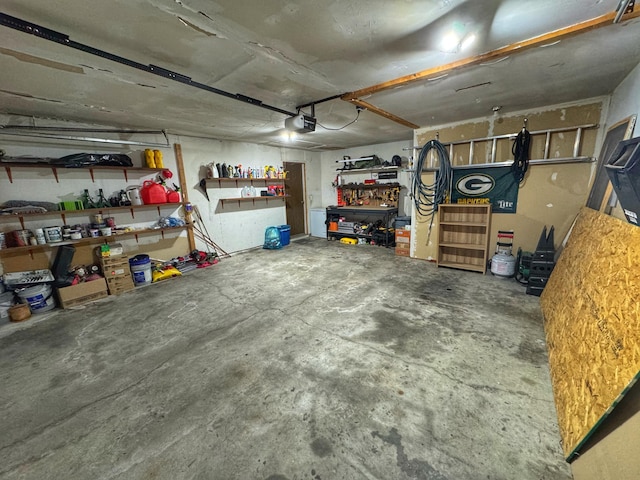 garage with a workshop area and a garage door opener