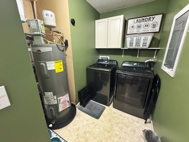 laundry area with washing machine and dryer, electric water heater, cabinet space, and a textured ceiling