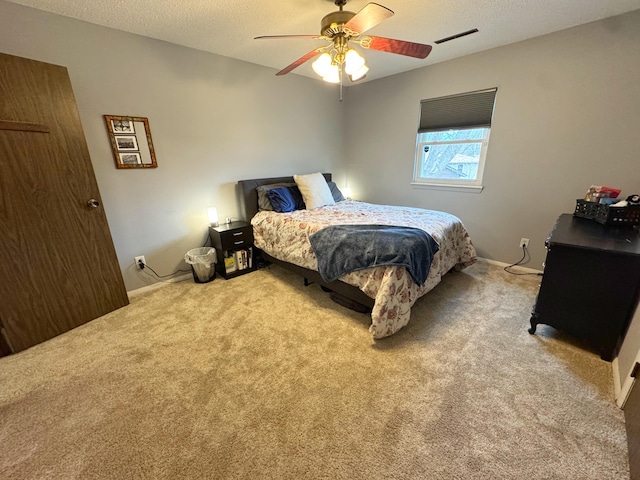 bedroom with a textured ceiling, ceiling fan, carpet, and visible vents