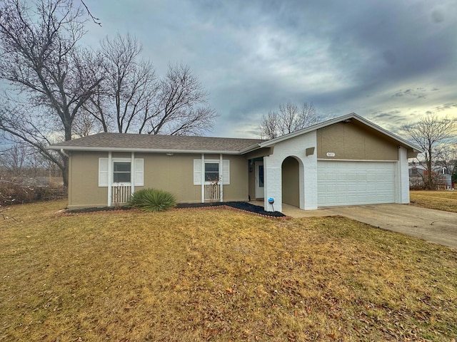 ranch-style house featuring a front yard, driveway, an attached garage, and stucco siding