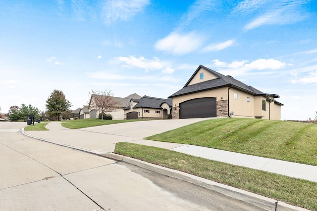 view of front of house featuring a garage, stucco siding, concrete driveway, and a front yard