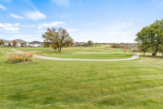 view of property's community featuring a lawn and golf course view