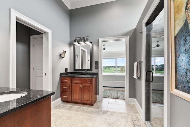 full bathroom with tile patterned flooring, two vanities, a ceiling fan, ornamental molding, and a stall shower