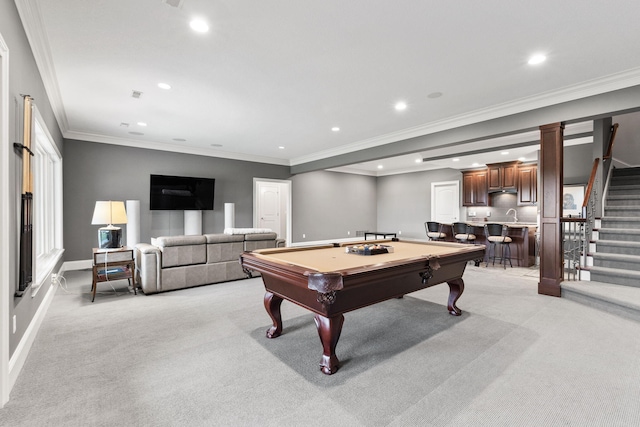 recreation room featuring recessed lighting, wet bar, crown molding, and light colored carpet