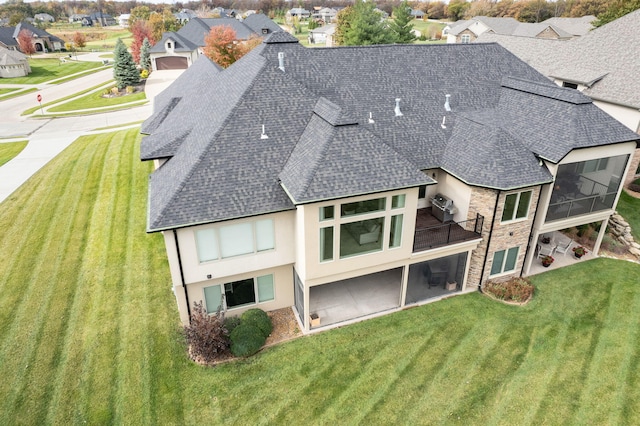 rear view of house featuring a residential view, stone siding, roof with shingles, and stucco siding