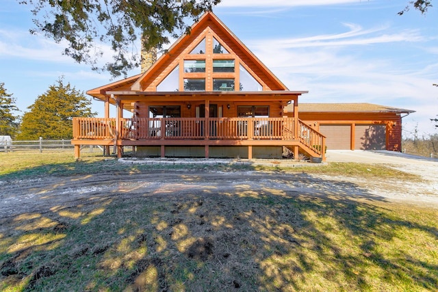 log cabin with a front yard, a chimney, fence, and an outdoor structure