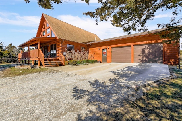 log-style house featuring driveway, a shingled roof, and a garage