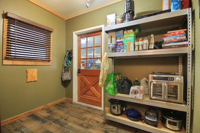 interior space featuring dark wood-style floors, crown molding, and baseboards