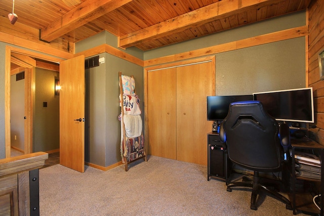 carpeted home office with wooden ceiling, wooden walls, visible vents, and beam ceiling