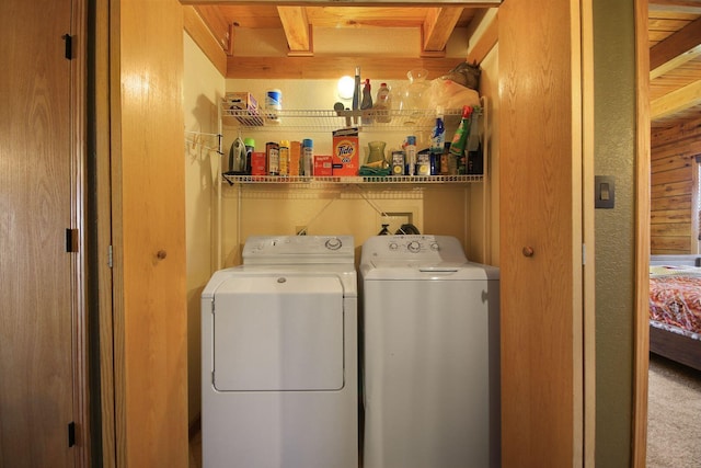 laundry room featuring laundry area, washing machine and dryer, and wooden walls