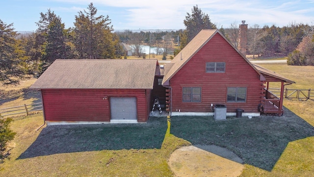 view of front of home with driveway, a front yard, and fence