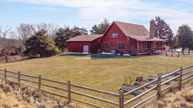 view of side of property featuring a yard, a chimney, cooling unit, and fence