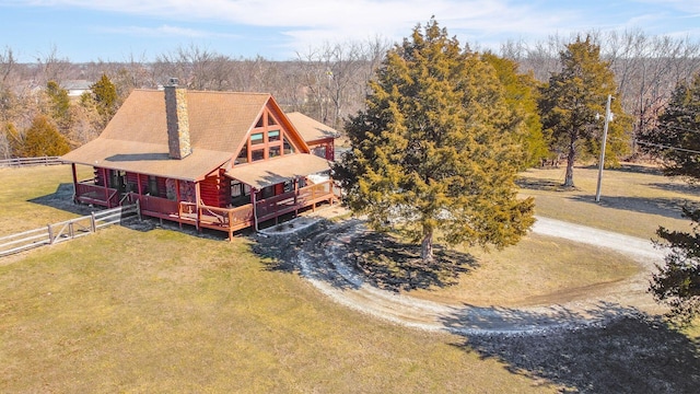 birds eye view of property with a view of trees