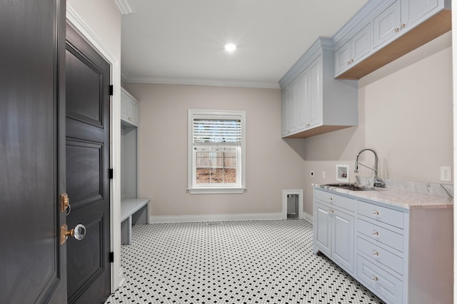 laundry area with washer hookup, cabinet space, ornamental molding, a sink, and electric dryer hookup