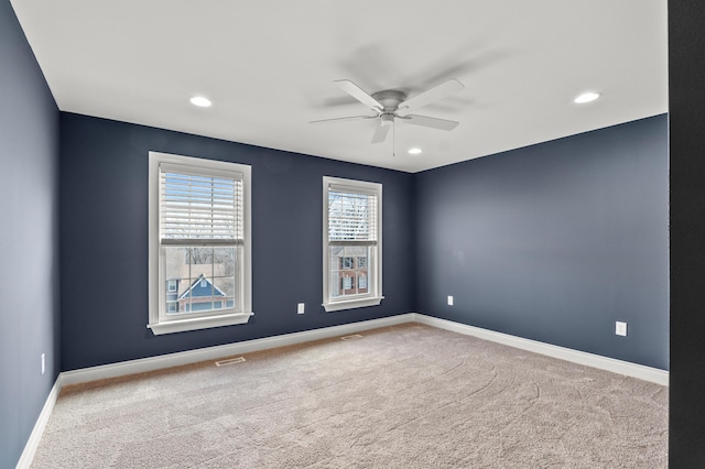 carpeted spare room featuring recessed lighting, visible vents, ceiling fan, and baseboards