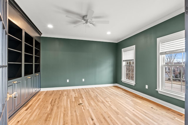 empty room featuring baseboards, visible vents, and ornamental molding