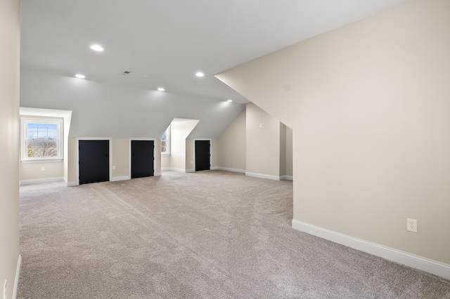 bonus room with recessed lighting, light carpet, lofted ceiling, and baseboards