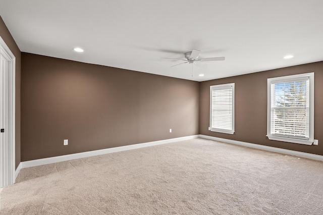 carpeted spare room with ceiling fan, recessed lighting, and baseboards