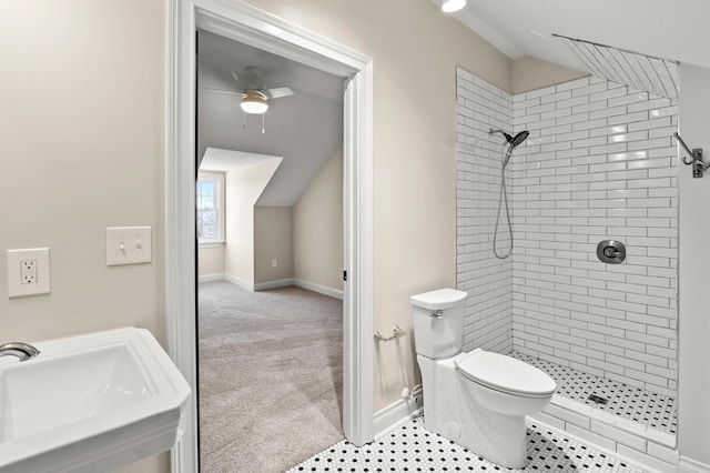 full bathroom with lofted ceiling, a sink, and a tile shower