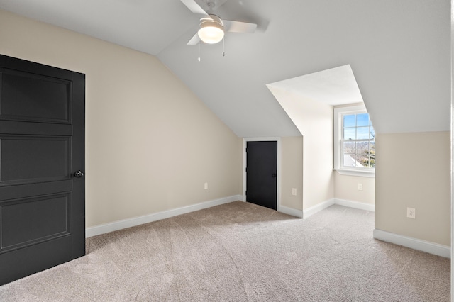 bonus room featuring baseboards, vaulted ceiling, a ceiling fan, and light colored carpet