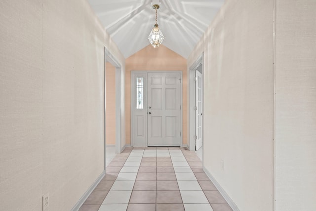 interior space featuring vaulted ceiling, light tile patterned floors, baseboards, and an inviting chandelier