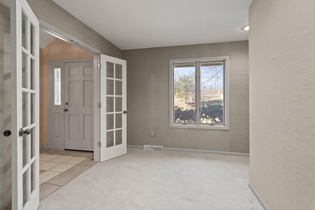 entryway with french doors, carpet, visible vents, and baseboards