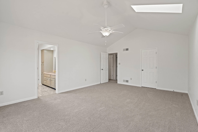 unfurnished bedroom with light colored carpet, a skylight, visible vents, and baseboards