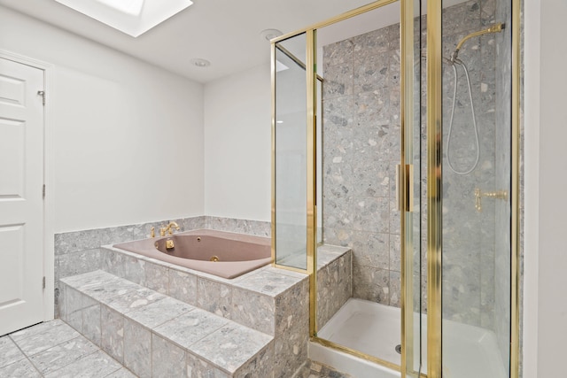 bathroom with a jetted tub, a stall shower, and a skylight