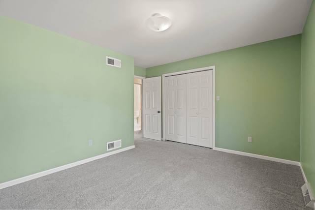 unfurnished bedroom featuring carpet, visible vents, and baseboards